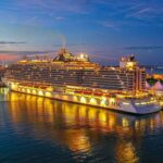 Luxury cruise ship sailing at sunset